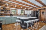 Fully equipped kitchen has quartz counters and new appliances